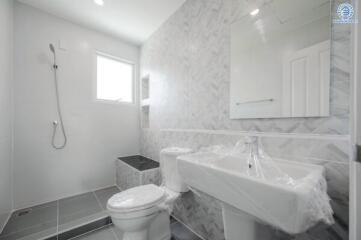 Modern bathroom with a shower area, toilet, and sink