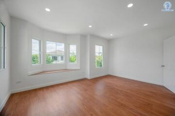 spacious bedroom with large windows