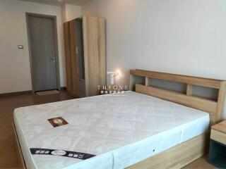 Bedroom with a wooden bed and wardrobe