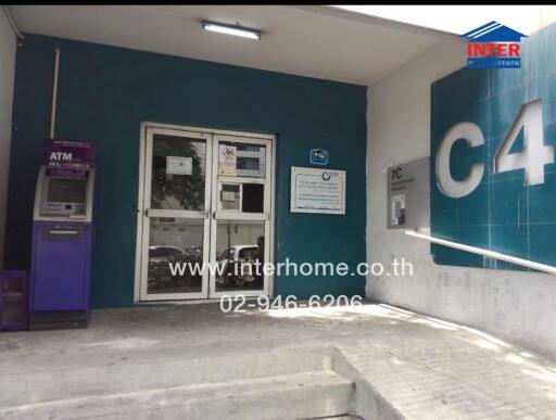 Entrance to a building with ATM and signage