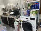 Utility room with washing machine and storage shelves