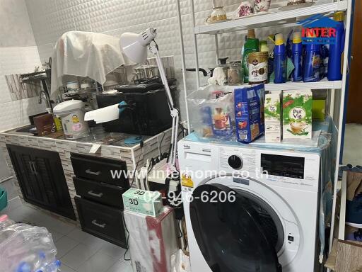 Utility room with washing machine and storage shelves