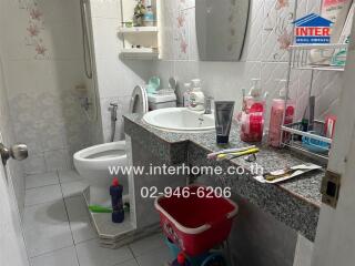 Bathroom with sink, countertop, and various toiletries