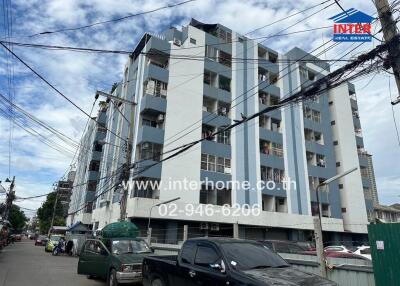 Exterior view of an apartment building with multiple floors and balconies.