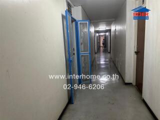 Hallway with open door and wall decoration