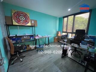 Home office with furnishings and large windows