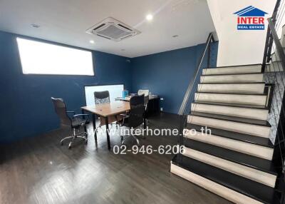 Modern office with dark flooring and stairway