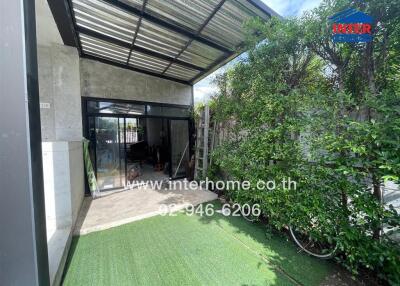 Covered patio area with garden and glass doors