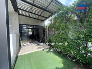 Covered patio area with garden and glass doors