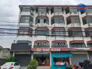 Exterior view of a commercial building with multiple floors and various storefronts