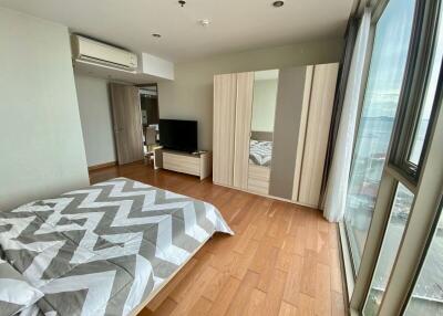 Bedroom with large window and modern furnishings