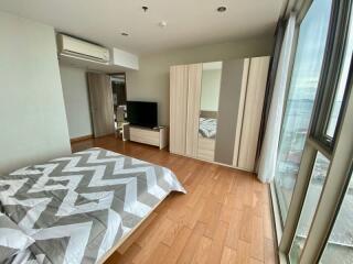 Bedroom with large window and modern furnishings