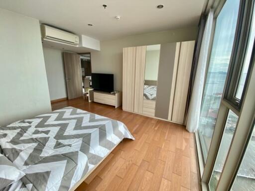 Bedroom with large window and modern furnishings