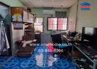 Home office with desk, chair, air conditioning, and tiled floor