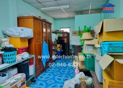 Cluttered storage room with various items and furniture