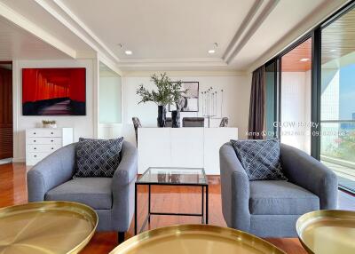 Modern living room with glass coffee table and armchairs