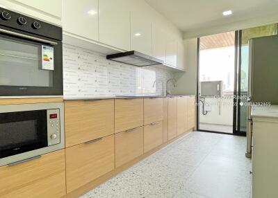 Modern kitchen with wooden cabinets and built-in appliances