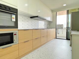 Modern kitchen with wooden cabinets and built-in appliances