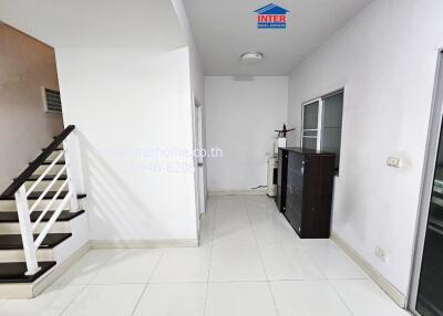 Bright hallway with white walls and stairs