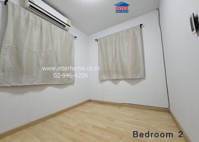 Bedroom with air conditioning and windows