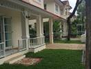 Front view of house with porches and green lawn