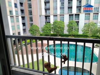 View of apartment complex from balcony with pool