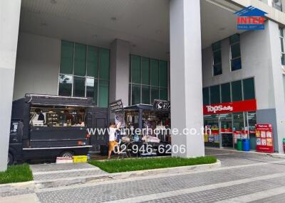 Commercial building entrance with food truck and convenience store