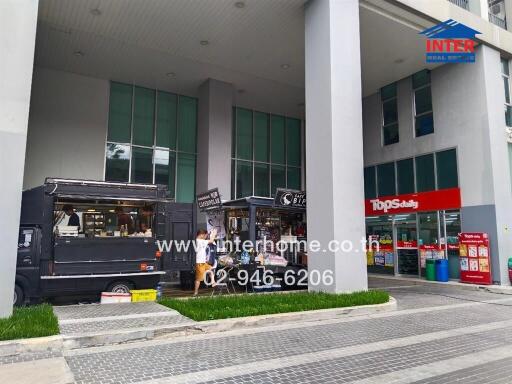 Commercial building entrance with food truck and convenience store