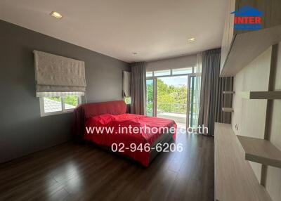 Modern bedroom with large window and red bedding