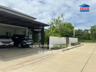 Front view of a house with two cars parked in the driveway