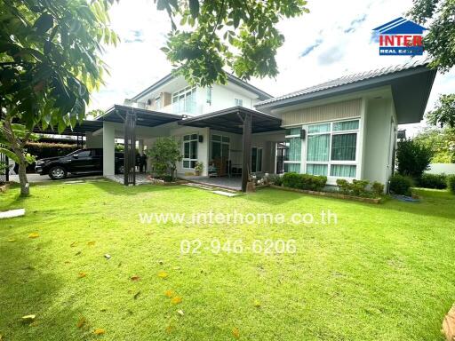 Exterior view of a house with a lush green lawn