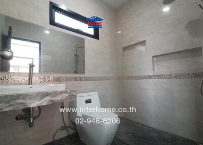 Modern bathroom with sink, toilet, and shower