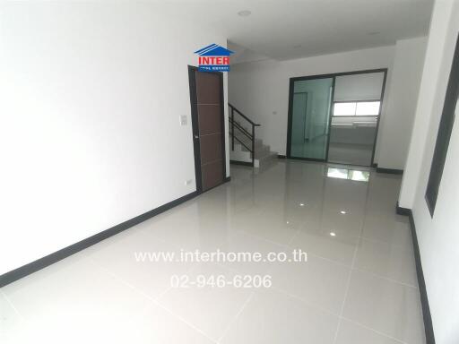 Modern living room featuring tiled flooring and a staircase