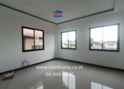 Spacious living room with large windows and glossy tiled floor