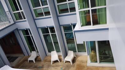 Exterior view of a modern building with large windows and patio area