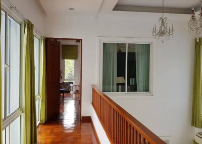 Bright hallway with wooden flooring and chandelier