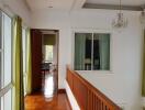 Bright hallway with wooden flooring and chandelier