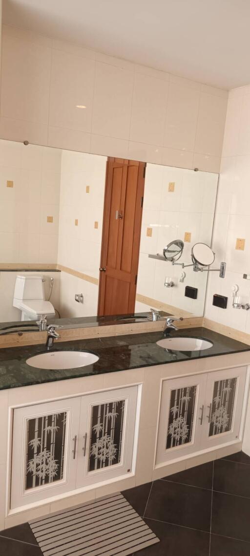 Modern bathroom with double sinks and large mirror