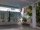 Outdoor patio with seating area and greenery