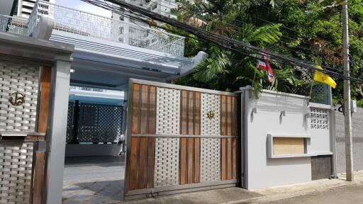 Front view of a building entrance with gated fence