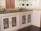 Modern bathroom with double sinks and wooden door