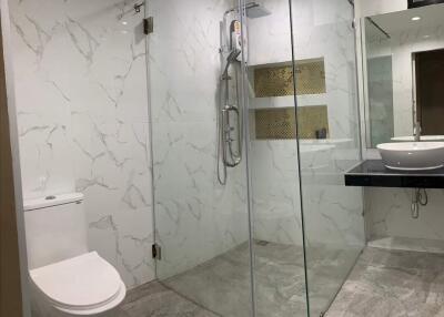 Modern bathroom with glass shower and white ceramic fixtures