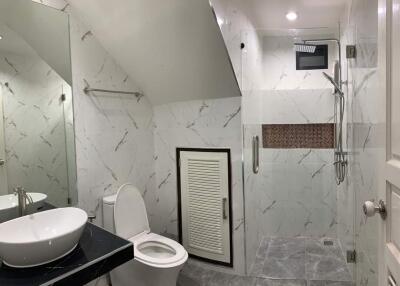 Modern bathroom with shower area and marble tiles