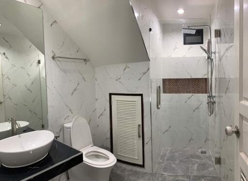 Modern bathroom with shower area and marble tiles