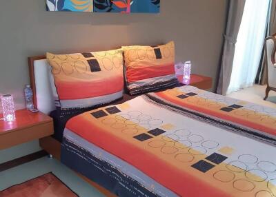Modern bedroom with colorful bed linen and wall art