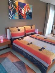 Modern bedroom with colorful bed linen and wall art