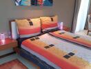 Modern bedroom with colorful bed linen and wall art