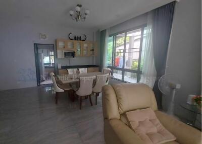 Spacious living room with dining area and natural light