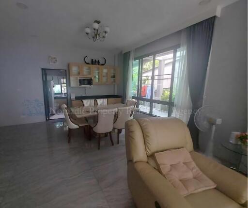 Spacious living room with dining area and natural light