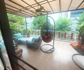 Spacious balcony with outdoor seating and hanging chair